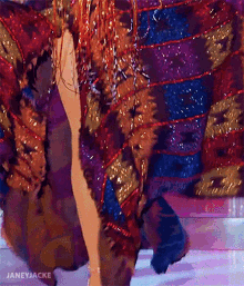 a close up of a woman 's leg in a colorful dress .