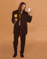 a man in a suit and tie is dancing with a yellow sticky note on his pocket
