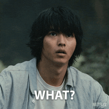 a man with a surprised look on his face has the word what written on his face