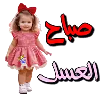 a little girl in a pink dress is standing next to a sign that says صباح الجمال