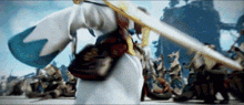 a person is holding a sword in front of a crowd .