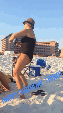 a woman in a bathing suit stands on a beach with the words happy birthday birds