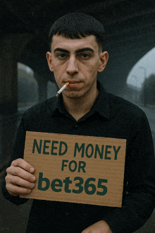 a man is smoking a cigarette and holding a cardboard sign that says need money for bet365