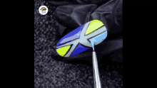 a close up of a colorful ball on a dark surface .