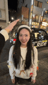 a woman standing in front of a ride taxi