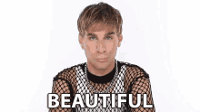 a man wearing a fishnet top with the word beautiful written on it .