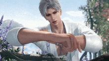 a man in a white shirt is holding a rosary in his hand and says who 's the real villain here