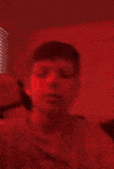 a close up of a person 's face in a red room .