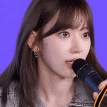 a close up of a girl holding a sennheiser microphone