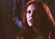 a close up of a woman with red hair