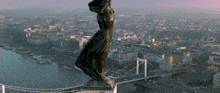 an aerial view of a city with a bridge and a statue