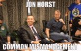 a man in a suit and tie sits at a table with a caption that says jon horst common mismanagement