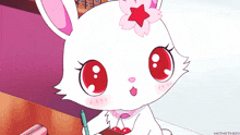 a white rabbit with red eyes and a flower on its head