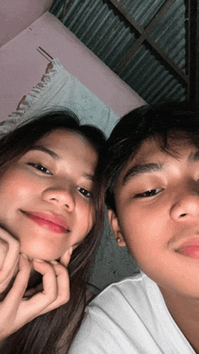 a boy and a girl are posing for a picture