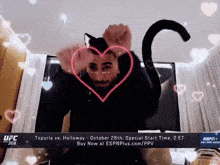 a man is wearing a cat costume with a heart on his face and a cat tail