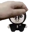 a hand is putting a stuffed animal on top of a stuffed animal .