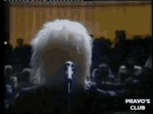 a man singing into a microphone with the words pravo 's club on the bottom right