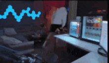 a blurry picture of a room with a computer desk and a couch