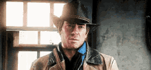 a man is wearing a cowboy hat and a leather jacket .