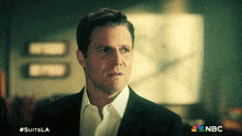 a man in a suit and white shirt is on a nbc ad