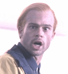 a man with red hair is making a funny face