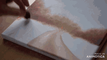 a painting is being painted on a canvas made in animatica