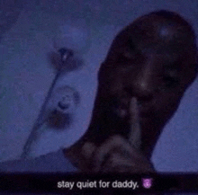 a man is making a quiet gesture with his finger to his mouth .