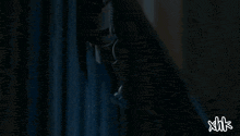 a man is jumping in the air with xhk written on the bottom right
