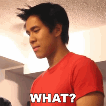 a man wearing a red shirt says what