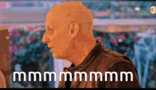 a bald man with the words mmmmm on the bottom right