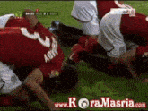 a soccer player with the number 3 on his back is kneeling down