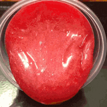 a close up of a red liquid in a clear container