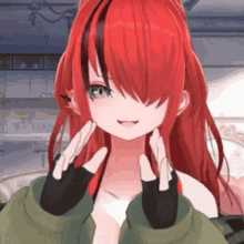 a girl with red hair and black eyes is wearing a green jacket and gloves .