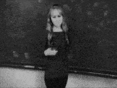 a woman is standing in front of a blackboard that says ' 3d ' on it