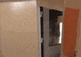 a door is open to a room with a painting on the wall