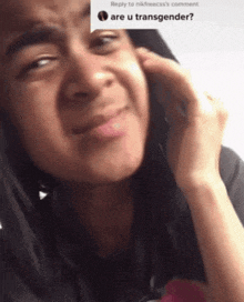 a woman is talking on a cell phone and making a face .