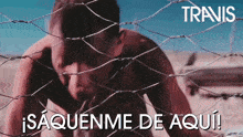 a man behind a barbed wire fence with the word travis on the bottom