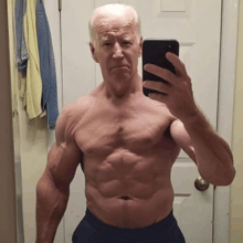 a shirtless man is taking a selfie with his cell phone