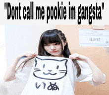 a girl holds up a shirt that says " dont call me pookie im gangsta " on it