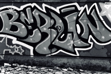 a black and white photo of graffiti on a wall that says bn