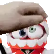 a close up of a stuffed animal with a hand covering its face .