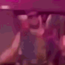 a blurry picture of a person wearing sunglasses in a room .