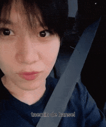 a close up of a person 's face with the words taemin de hansel above it