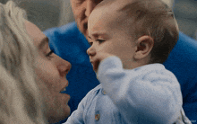 a baby is being held by a woman and a man with kepler written on the bottom