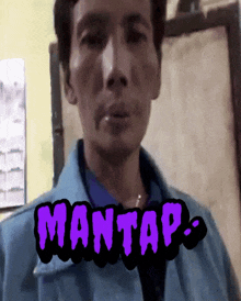 a man in a blue jacket with the word mantas on the bottom