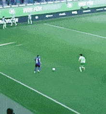 a soccer game is being played on a field with a banner that says wir fur