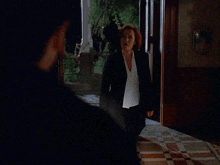 a man and a woman are looking at each other with a serious look on their faces