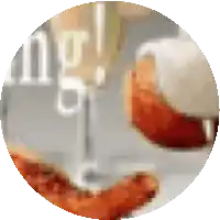 a blurred image of a glass of wine and a plate of food