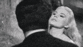 a black and white photo of a woman and a man