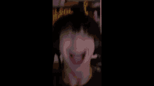 a blurry picture of a person 's face with their mouth open